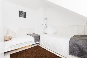 a white bedroom with a bed and a couch at Apartments Neuss in Neuss
