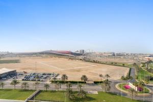 an aerial view of a parking lot with a park at Silkhaus Canalside 1BR at Water's Edge in Yas Island in Abu Dhabi