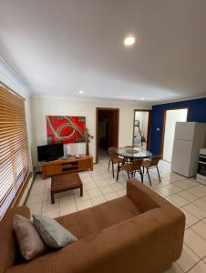 a living room with a couch and a table at Wildsights Beach Units in Denham +12 photos