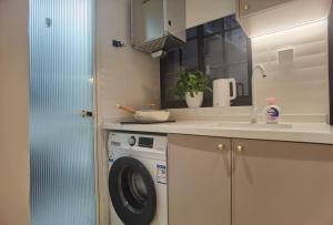 a kitchen with a washing machine and a sink at HuanChang in Shanghai