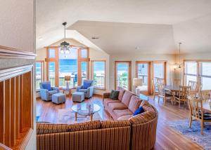 a living room with a couch and a table at 6067 - Sand Pebble in Nags Head