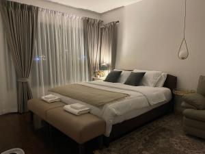 a bedroom with a large bed and a window at Baan Sandao Condo Hua Hin in Hua Hin +35 photos