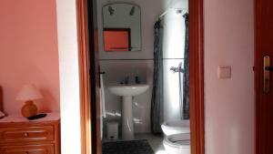 a bathroom with a sink and a toilet at Pousada Farol do Portinho in Vila Praia de Âncora