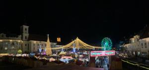 a christmas market in a city at night at View of Main Square Studio in Sibiu