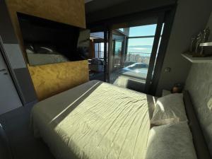 a bedroom with a bed and a view of a balcony at Magic VieW Luxury Penthouse with Jacuzzi and Sea view in Split