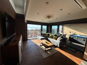 a living room with a couch and a pool table at Magic VieW Luxury Penthouse with Jacuzzi and Sea view in Split
