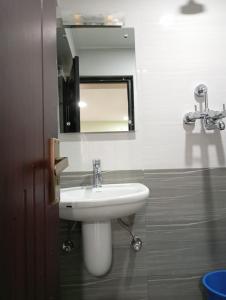 a bathroom with a sink and a mirror at Pilachhen 1 bhk in Pātan