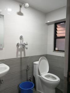 a bathroom with a toilet and a sink at Pilachhen 1 bhk in Pātan