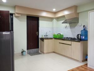 a kitchen with a sink and a stove at Pilachhen 1 bhk in Pātan