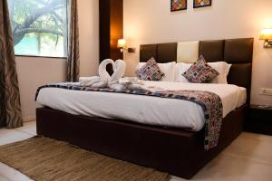 a hotel room with a bed with a towel on it at HHW Hotel- Agra in Agra +150 photos