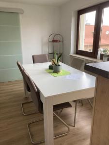 a white table and chairs in a room at Weitblick in Niederkirchen bei Deidesheim
