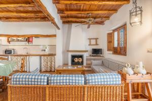 a living room with a couch and a fireplace at Casa Rural El Corral in La Zubia