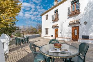 a table and chairs in front of a building at Apartamento La Cuadra in La Zubia