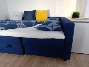 a blue couch with pillows on it in a room at Apartmán Bezruč in Nová Paka