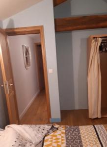 a bedroom with a bed and a door to a hallway at les bleuet in Cours +3 photos