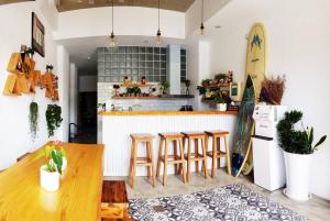 a kitchen with a table and chairs and a surfboard at The Red Hotel in Nanwan