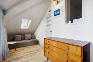 a living room with a couch and a dresser at Surfcastle bnb and Surf School in Ferrel