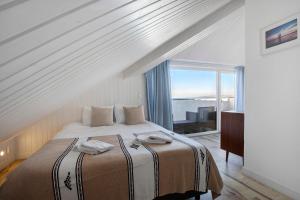 a bedroom with a bed and a large window at Surfcastle bnb and Surf School in Ferrel