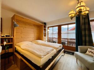 a bedroom with a bed and a large window at Haus Baur, Fewo Dorfstadl 37 oder Heustadl 38 in Oberstdorf