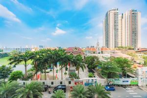 a view of a city with palm trees and buildings at Masteri Thao Dien Riverside Apartment in Ho Chi Minh City