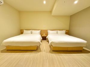 Voodi või voodid majutusasutuse Brown House Hotel - Taipei Main Station toas