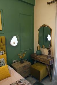 a bedroom with a mirror and a table and a bed at Χρυσηίδα - Chrysiida Luxury Apartment in Nafplio