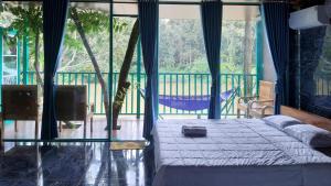 a bedroom with a bed and a large window at Quang Minh Riverview Resort in Kroun