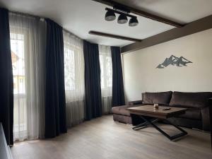 a living room with a couch and a coffee table at Elite Apartments Complex Iglika Borovets in Borovets +26 photos