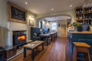 a bar with a fireplace in a restaurant at The Redan Inn in Chilcompton