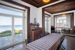 a dining room with a table and a view of the ocean at Surfcastle bnb and Surf School in Ferrel