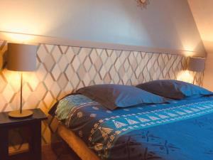 a bedroom with a bed with a metal headboard at Gites de Gondières in Saint-Éloi