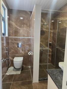 a bathroom with a shower and a toilet at Satish Villa in Hyderabad +17 photos