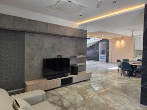 a living room with a flat screen tv on a wall at Satish Villa in Hyderabad