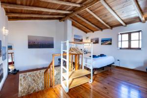 a bedroom with a bunk bed and a ladder at Casa Azul - Aljezur Town in Aljezur