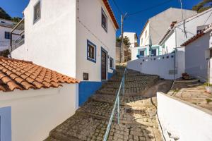 a street in positano with blue and white houses at Casa Azul - Aljezur Town in Aljezur +17 photos
