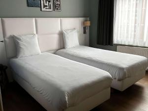Postel nebo postele na pokoji v ubytování greet hotel Lille Gare Flandres - Groupe Accor