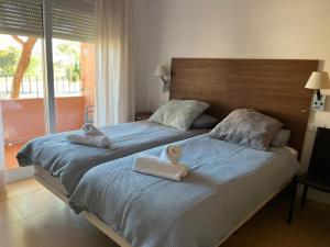 a bedroom with two beds with towels on them at Beautiful 2 Bed Apartment Mar Menor Golf Resort in Los Martínez +16 photos
