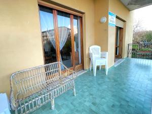a porch with a bench and chairs on a balcony at Casa Gargiulo in Massa Lubrense