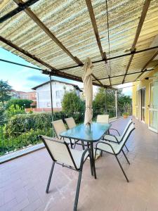 a patio with a table and chairs under a roof at Casa Gargiulo in Massa Lubrense