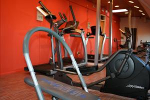 a gym with several tread machines in a room at Hotel Don Luis Puerto Montt in Puerto Montt