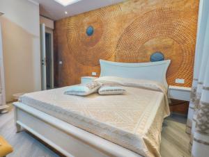 a bedroom with a bed with two pillows on it at Sa Pintadera in Olbia