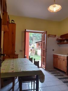 a kitchen with a table and a door to a yard at Casa vacanze Villa Marcella in Maratea