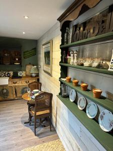 a room with a table and plates on the wall at The Old Post Office in Orston