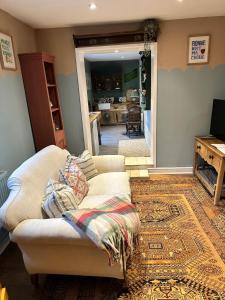 a living room with a couch and a fireplace at The Old Post Office in Orston