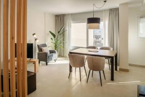a dining room with a table and chairs at Panasco Suites in Arrecife