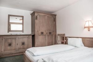 a bedroom with two beds and a mirror on the wall at Ferienhaus Rehhaus in Holzgau