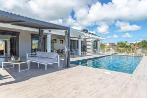 a villa with a swimming pool and a house at Villa Mélina in Capesterre-de-Marie-Galante
