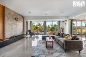 a living room with a couch and a table at The Rivernook - The perfect place for getaways in Jambur +22 photos