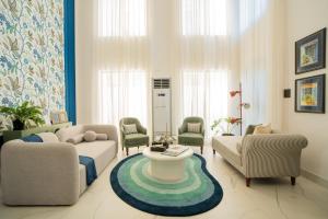 a living room with two couches and a table at ELIVAAS Villa Paraiso 4 BHK with Pool & Bar in Camorlim +83 photos