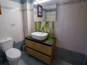 a bathroom with a sink and a toilet and a mirror at Almond's Room in Mirina